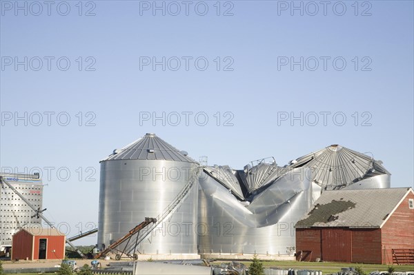 Tornado storm damage to grain bins on farm