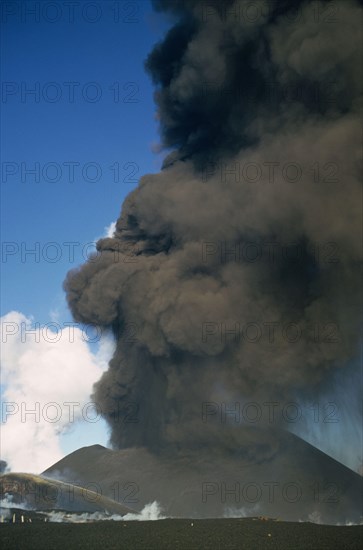 Rising column of smoke and ash from erupting volcano