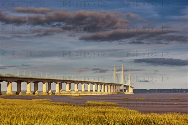 View of the road bridge over the river at sunset