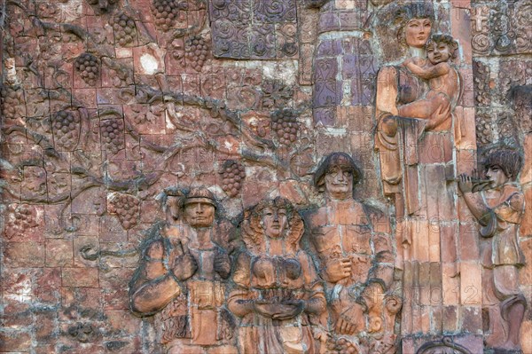 Close-up of communist-era faces on the facade of the city market