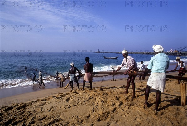 Fishermen hauling the fishing nets in Vizhinjam near Thiruvananthapuram