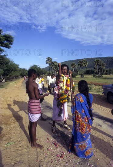 The Poojari or Pujari of Village guardian temple blessing the people during a village festival