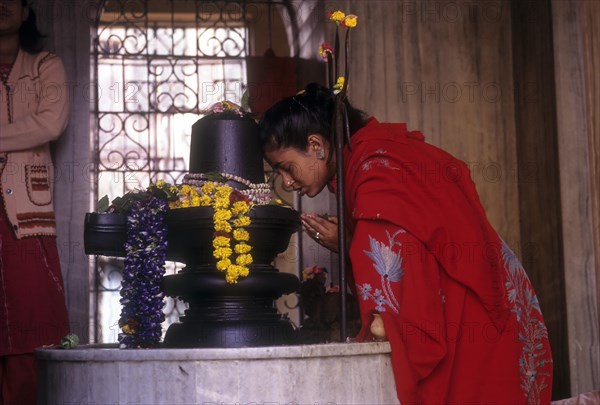 A woman worshipping Siva in Kalighat Kali temple in Kolkata or Calcutta