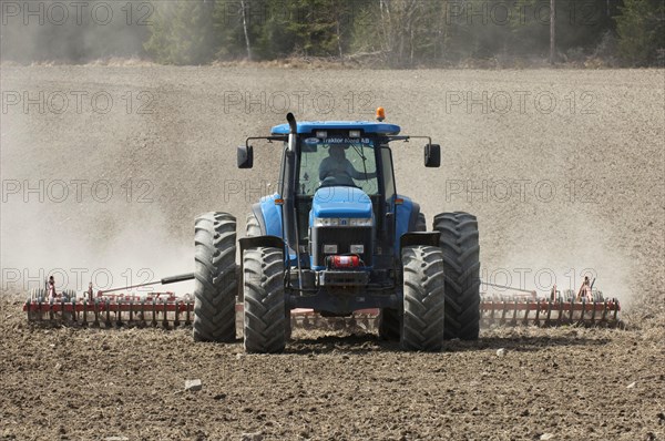 New Holland 8770 tractor with harrows