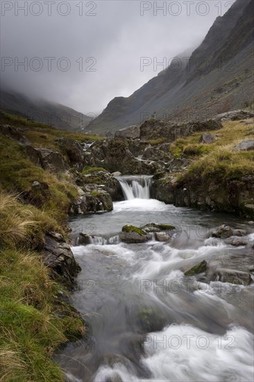 High mountain stream with cascade