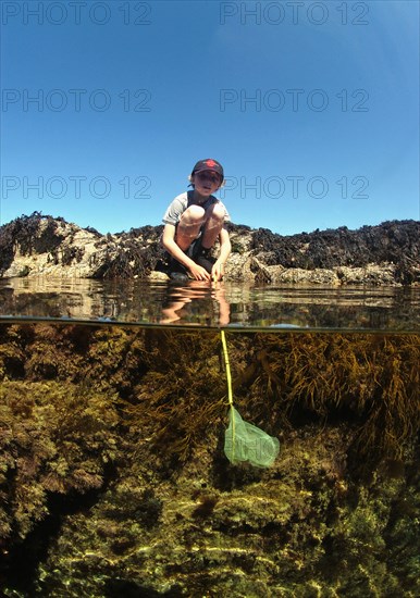 Rock pooling of boys in coastal rock pools