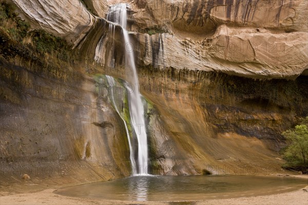 Waterfall cascading over navajo sandstone