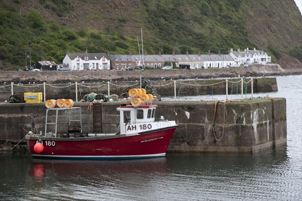 Lobster fishing boat at harbour of fishing village Burnmouth