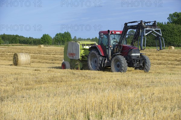 Case MX120 tractor with Trima loader and Claas round baler