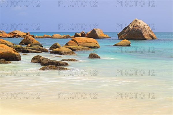 Granite rocks and beach of Anse Lazio in the evening