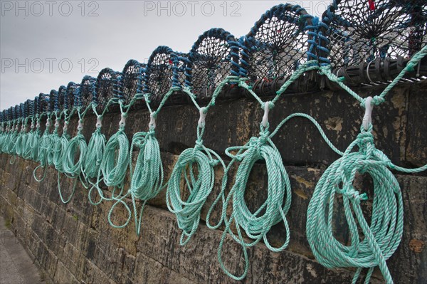 Lobster pots on quayside of harbour