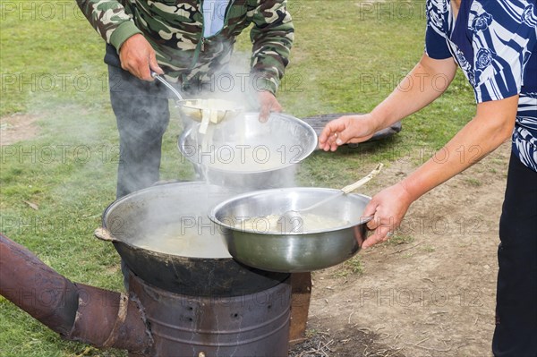 Kazakh nomads preparing noodles