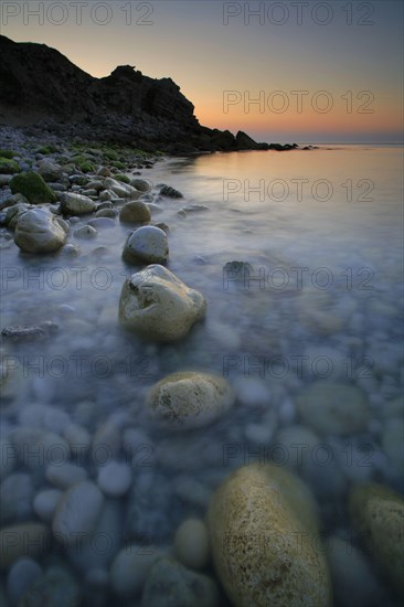 Pebbles on the beach at sunrise