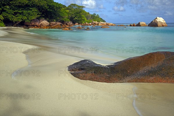 Beach and rocks of Anse Lazio in the evening