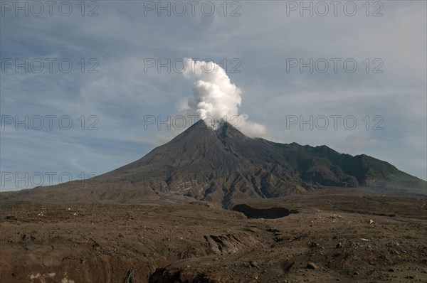 Recently erupted volcano with ash clouds