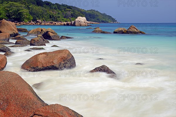 Granite rocks and beach of Anse Lazio in the evening