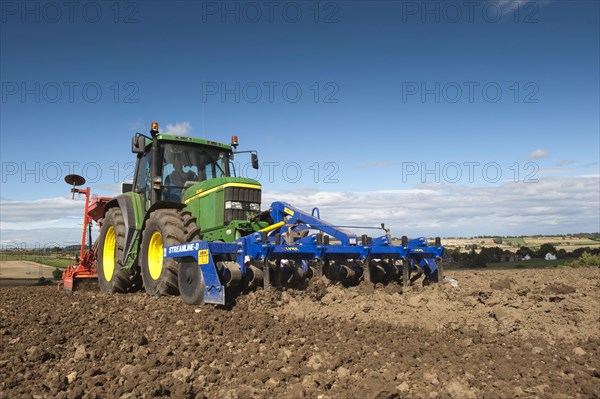 John Deere tractor with front press and rear seed drill