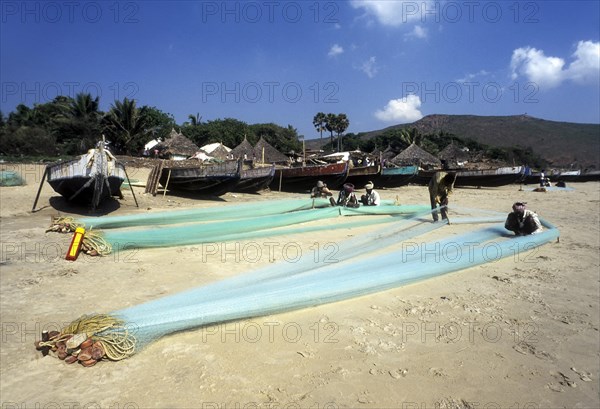 Fishermen repairing their fishing nets in Gangavaram
