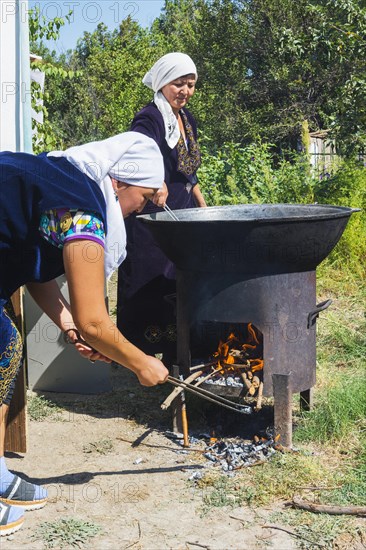 Kazakh woman preparing traditional local tandyr bread