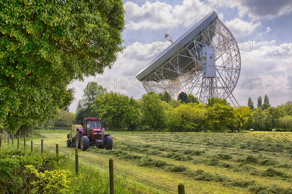 Radio telescope with tractor and baler with silage in foreground