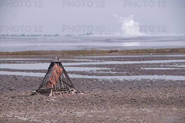 Mosque buried in mud lake of mud volcano