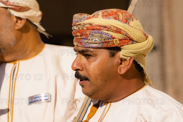 Man performing traditional songs during the Friday Goat Market in Nizwa