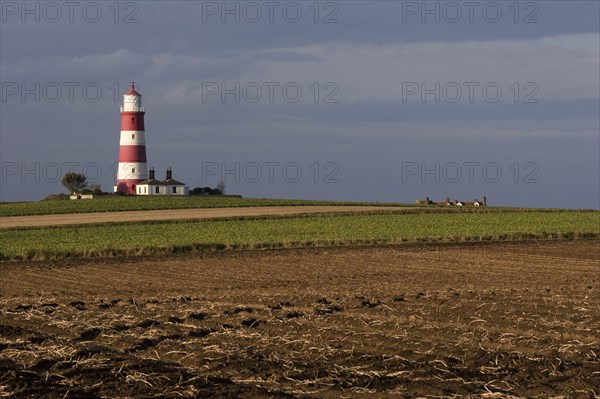 View across fields towards lighthouse