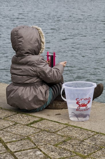 Young girl crabbing on cold day