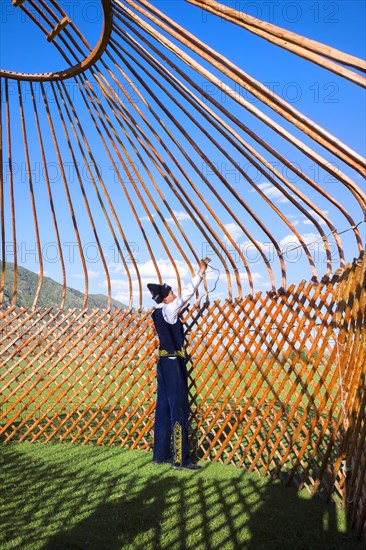 Kazakh men building a yurt