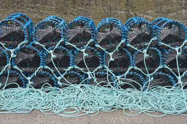 Lobster pots on quayside of harbour