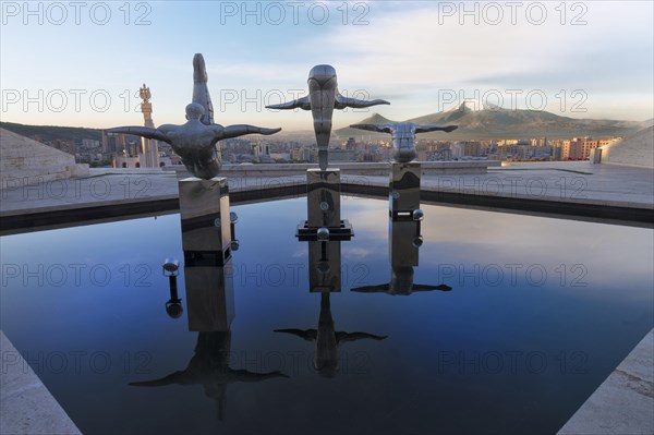 Modern sports sculptures reflected in the water