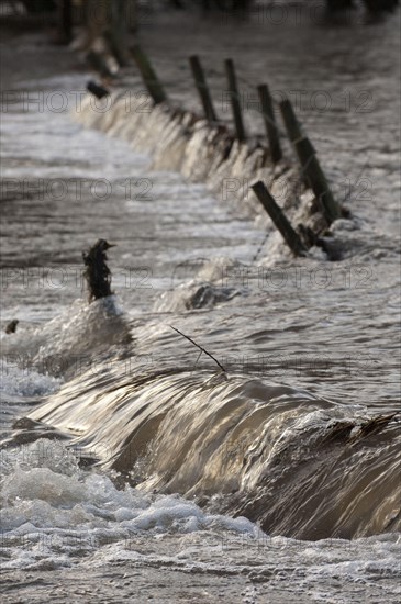 Flooded farmland with damaged fence