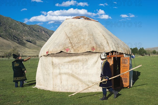 Kazakh men building a yurt