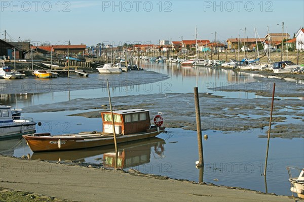 View of coastal creek with boats at low tide