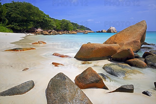 Granite rocks and beach of Anse Lazio in the evening