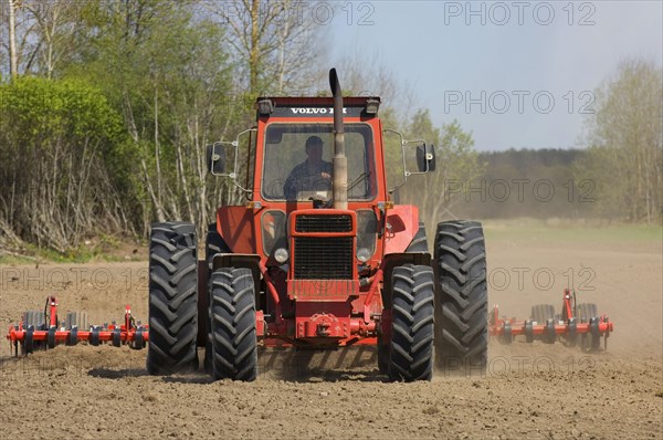 Volvo tractor pulling harrows