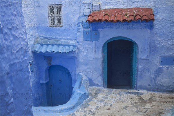 Blue doors and houses in alley of city