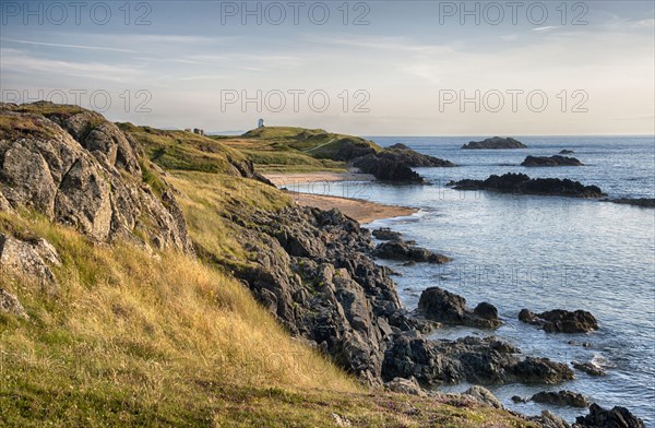 View of rocky coastline and beach on tidal island