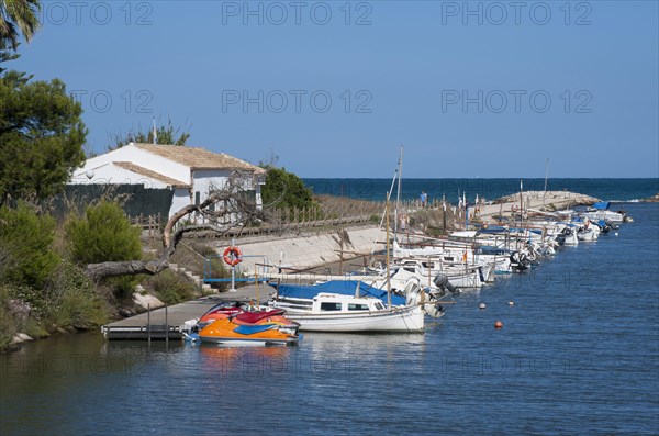 Boats and jet skis moored at jetty