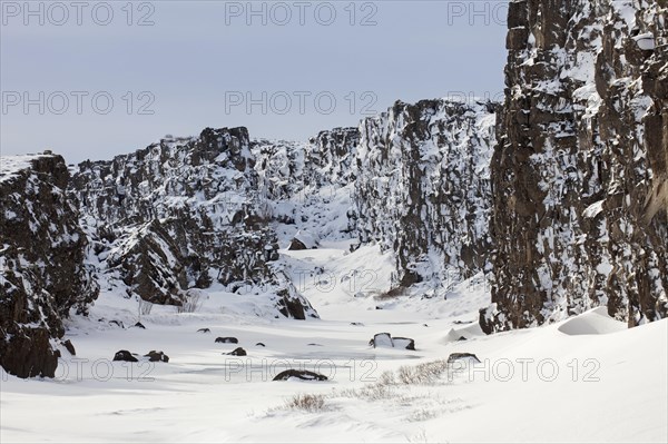 Oexara River flowing through Almannagja Gorge in the snow in winter