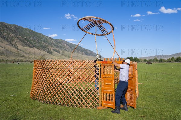 Kazakh men building a yurt