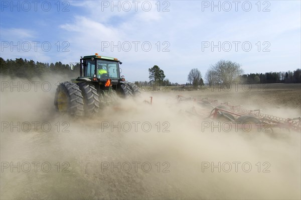 John Deere tractor pulling Vaderstad cultivator