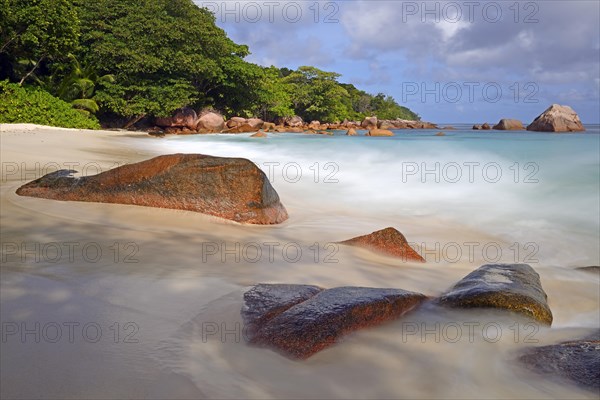 Beach and rocks of Anse Lazio in the evening