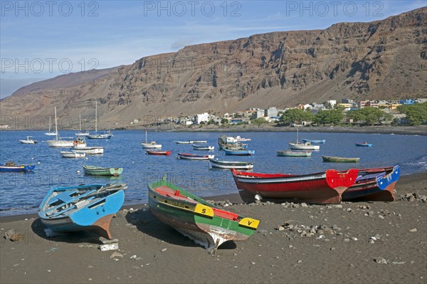 Colourful wooden fishing boats on the black sand beach of Tarrafal de Sao Nicolau on the island of Sao Nicolau