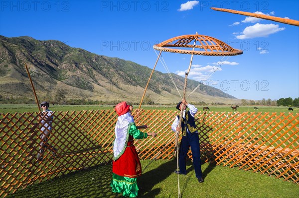 Kazakh men building a yurt