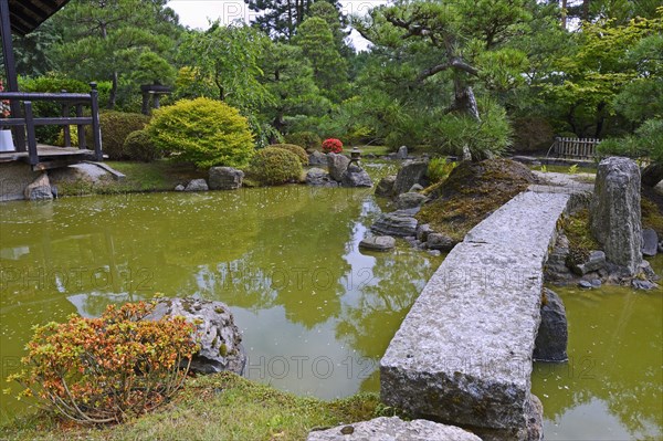 Typical Japanese garden with stone decorations and koi pond