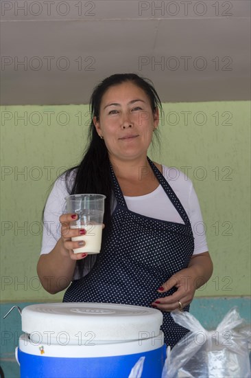 Kazakh woman selling kumis made from mare's milk