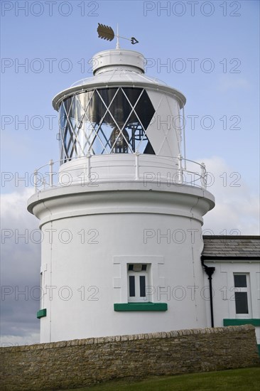 White painted lighthouse on the coast