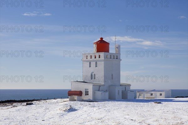 Dyrholaey lighthouse near Vik i Myrdal on the central south coast of Iceland in the snow in winter