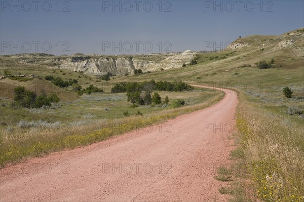 View of red scoria road in ranch country